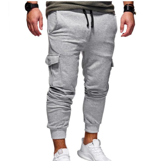men sport sweatpants jogger pants with elastic waist and side buttons, styled for a casual streetwear look.