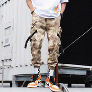 Stylish hip hop jogger pants in camo pattern, featuring cargo pockets and paired with trendy sneakers.