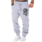 mens fashion casual dragon jogger pants with elastic waist and side buttons, styled for a casual streetwear look.